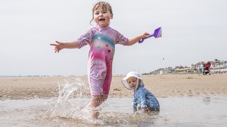Esmae Crawforth (left) and Ione Crawforth (right) enjoy the hot weather on Bridlington beach in Yorkshire. Picture date: Thursday June 16, 2022.