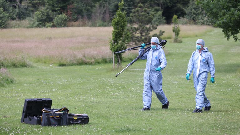 Police forensic officers at the scene where a body was found after a fire in the early hours of this morning in Belvue Park, west London.