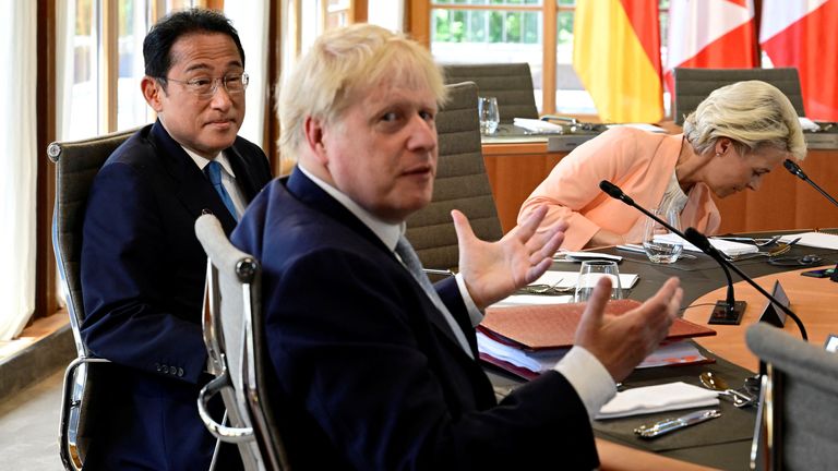 Boris Johnson gestures during the G7 roundtable meeting in Germany