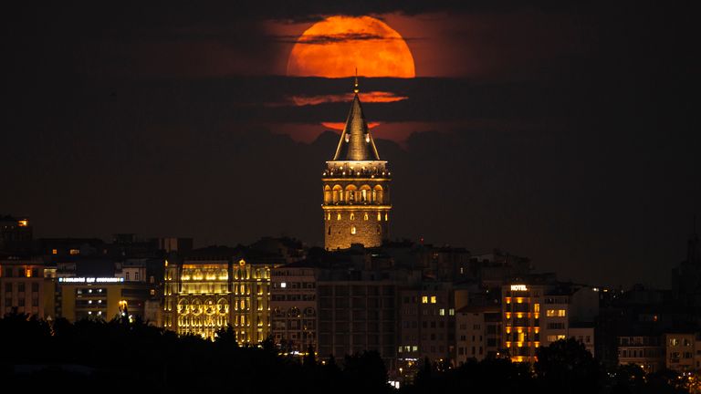 A supermoon rises behind the Galata Tower in Istanbul, Turkey, Tuesday, June 14, 2022. The moon reached its full stage on Tuesday, during a phenomenon known as a supermoon because of its proximity to Earth, and it is also labeled as the "Strawberry Moon" because it is the full moon at strawberry harvest time.  
PIC:AP