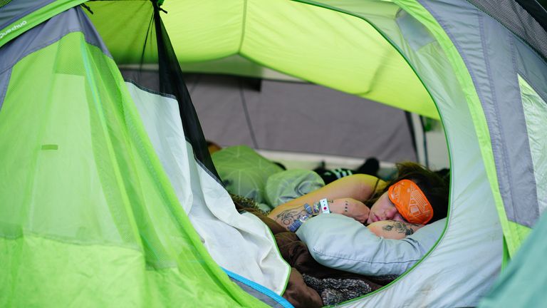A festival goer gets some rest during the Glastonbury Festival at Worthy Farm in Somerset. Picture date: Sunday June 26, 2022.

