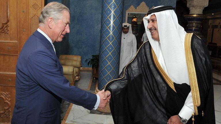 The Prince of Wales shakes hands with the Qatari Prime Minister Sheikh Hamad Bin Jassim al Thani, at his residence outside Doha, Qatar, during a visit in 2013