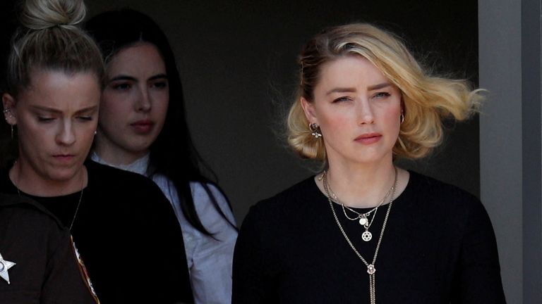 Amber Heard leaves Fairfax County Circuit Courthouse after the jury announced split verdicts