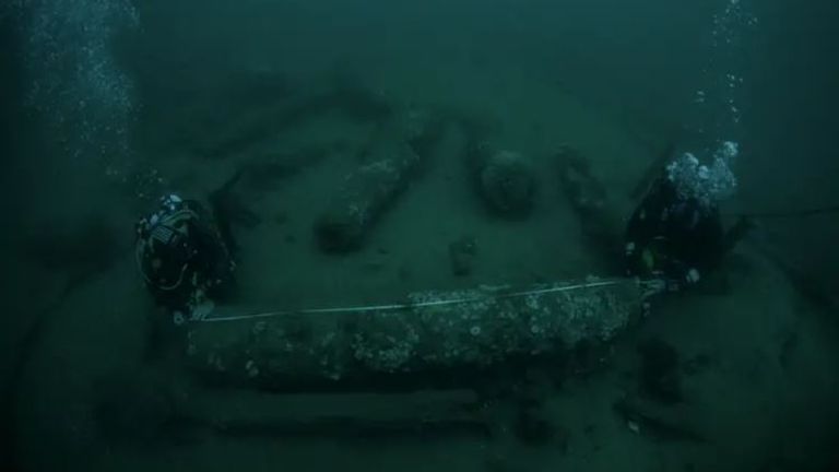 Julian and Lincoln Barnwell measuring a cannon that was found with the wreck.