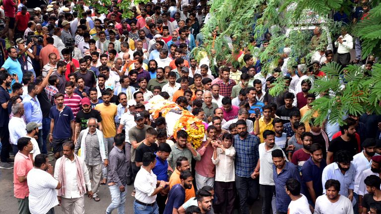 People carry the body of a Hindu man for cremation