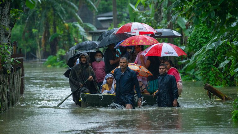 Indian army personnel rescue villagers affected by floods on a boat in Jalimura village, west of Gauhati, India, Saturday, June 18, 2022. (AP Photo/Anupam Nath)