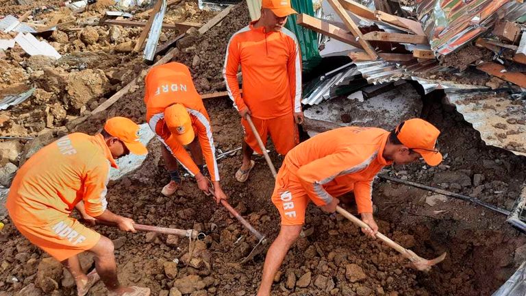 Rescue workers try to find those buried under the debris. Pic: AP