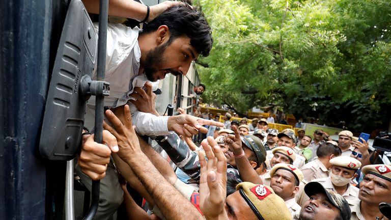 An activist of Bajrang Dal, a Hindu hardline group, reacts after he was detained by police during a protest against the killing of a Hindu man in the city of Udaipur, a day after two Muslim men posted a video claiming responsibility for slaying him, in New Delhi, India, June 29, 2022. REUTERS/Amit Dave
