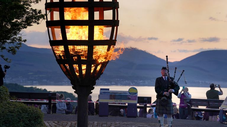 A Platinum Jubilee beacon is lit on Lyle Hill, Greenock as Piper Major John MacLeod of Inverclyde Pipes and Drums plays on day one of the Platinum Jubilee celebrations. Over 3,000 towns, villages and cities throughout the UK, Channel Islands, Isle of Man and UK Overseas Territories, and each of the capital cities of Commonwealth countries are lighting beacons to mark the Jubilee. Picture date: Thursday June 2, 2022.
