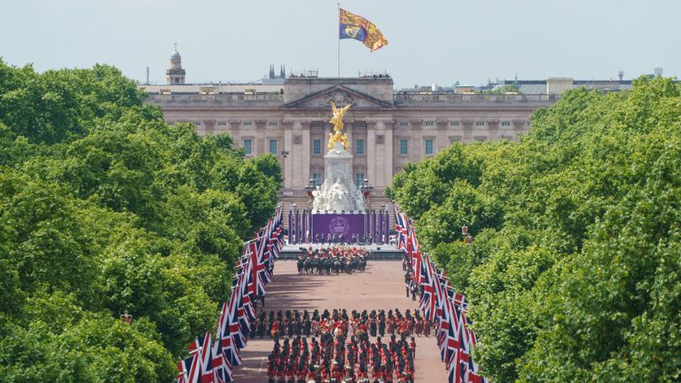 Troops march along the Mall towards Buckingham Palace