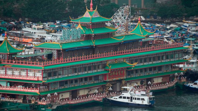 Hong Kong&#39;s iconic Jumbo Floating Restaurant is towed away in Hong Kong, Tuesday, June 14, 2022. Hong Kong&#39;s iconic restaurant on Tuesday departed the city, after its parent company failed to find a new owner and lacked funds to maintain the establishment amid months of COVID-19 restrictions. (AP Photo/Kin Cheung)