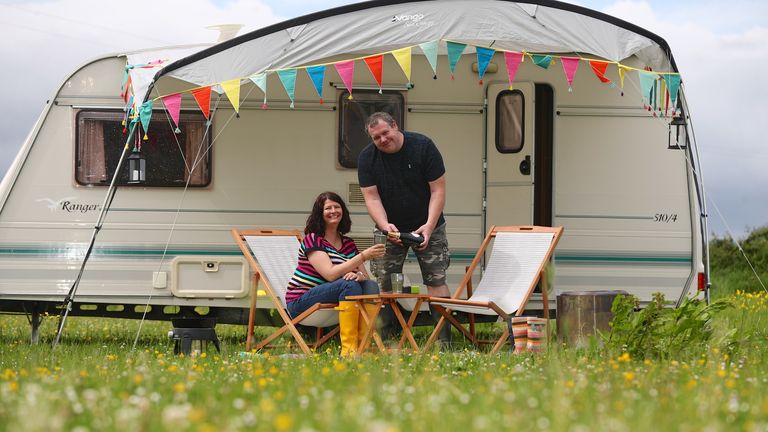 Couple attending a festival in a used caravan