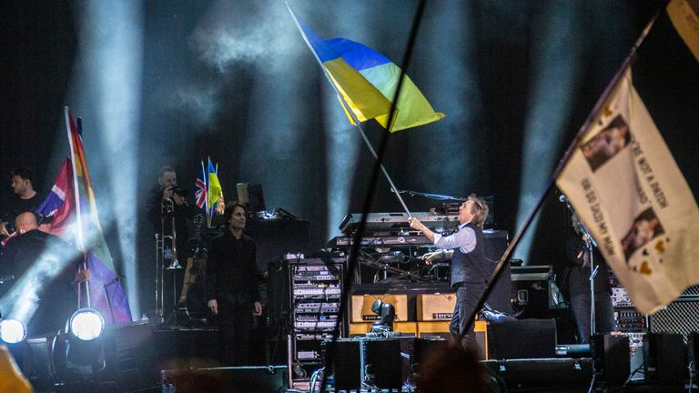 Paul McCartney waves the Ukrainian flag during a concert on the Pyramid Stage at the Glastonbury Festival at Worthy Farm, Somerset, England, Saturday June 25.  Photo: AP
