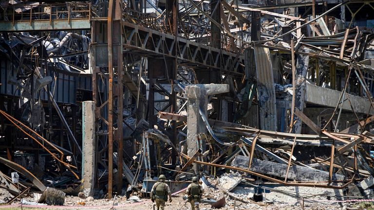Russian soldiers walk through debris of the Metallurgical Combine Azovstal, in Mariupol, on the territory which is under the Government of the Donetsk People&#39;s Republic control, eastern Ukraine, Monday, June 13, 2022. The plant was almost completely destroyed during the siege of Mariupol. This photo was taken during a trip organized by the Russian Ministry of Defense. (AP Photo)
PIC:AP