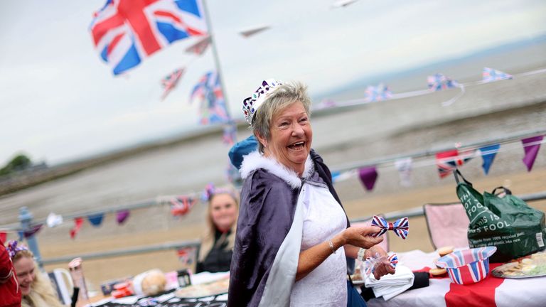 A woman reacts as she takes part in the Morecambe Town Council street party as part of celebrations marking the Platinum Jubilee of Britain&#39;s Queen Elizabeth, on Morecambe Promenade in Morecambe, Britain, June 5, 2022. REUTERS/Carl Recine
