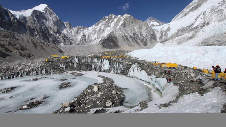 FILE - In this Saturday, April 11, 2015 file photo, tents are seen set up for climbers on the Khumbu Glacier, with Mount Khumbutse, center, and Khumbu Icefall, right, seen in background, at Everest Base Camp in Nepal. An avalanche triggered by a massive earthquake in Nepal smashed into a base camp between the Khumbu Icefall, a notoriously treacherous rugged area of collapsed ice and snow, and the base camp where most climbing expeditions are, said Ang Tshering of the Nepal Mountaineering Association. (AP Photo/Tashi Sherpa, File)                                                                                                                                                                                                                                                                             