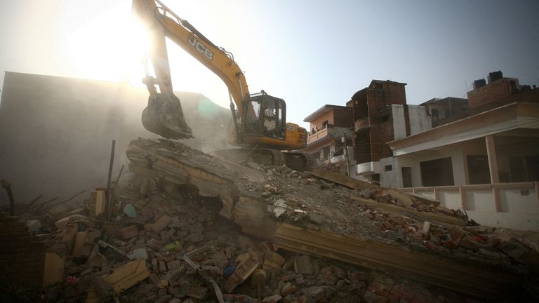 A bulldozer demolishes the house of a Muslim man that Uttar Pradesh state authorities accuse of being involved in riots last week, that erupted following comments about Prophet Mohammed by India&#39;s ruling Bharatiya Janata Party (BJP) members, in Prayagraj, India, June 12, 2022. Authorities claim the house was illegally built. REUTERS/Ritesh Shukla TPX IMAGES OF THE DAY
