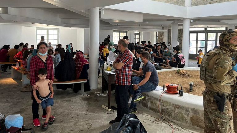 Migrants are seen in a shelter, following a rescue operation on the island of Delos,