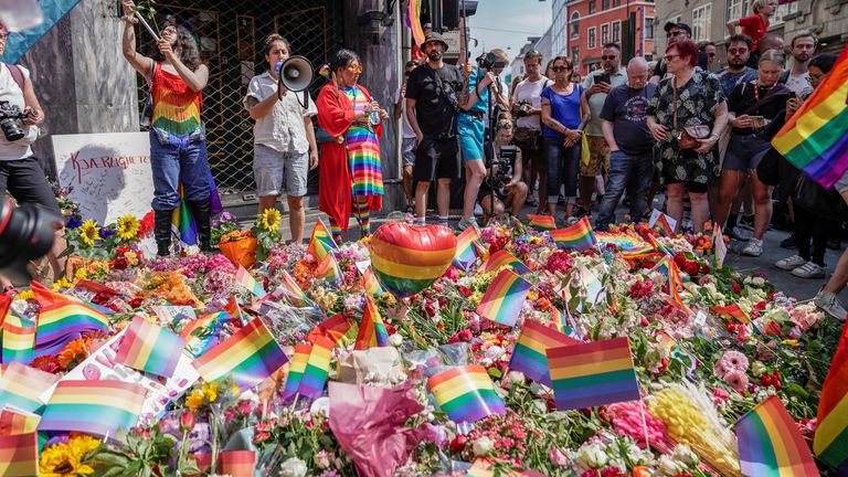 People taking part in a spontaneous Pride parade arrive at the London Pub, a popular gay bar and nightclub, to pay tribute to the victims of the shooting