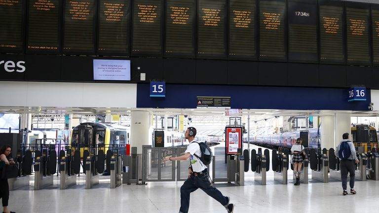 A passenger runs to catch a train at Waterloo station on the first day of the rail strike