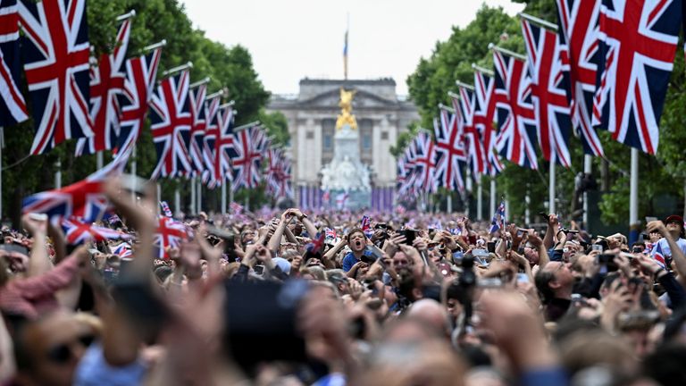 People gathered on The Mall watch a fly-past over Buckingham Palace during celebrations marking the Platinum Jubilee of Britain&#39;s Queen Elizabeth, in London, Britain, June 2, 2022. REUTERS/Dylan Martinez