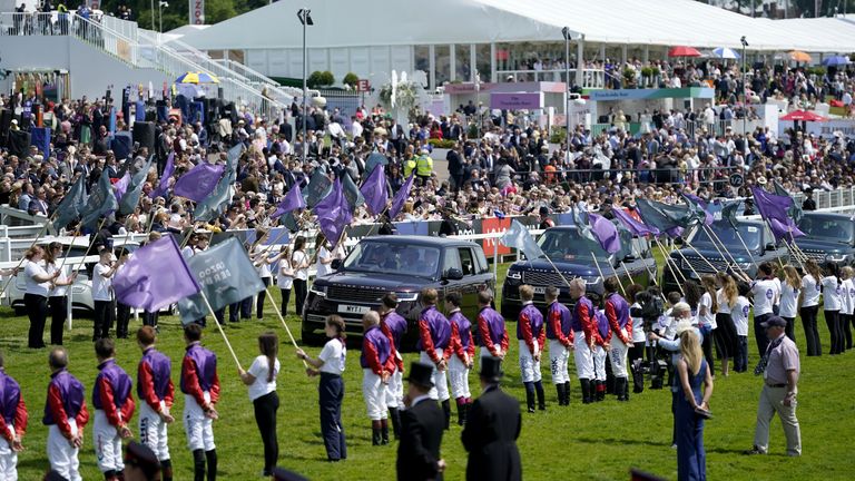 Members of the royal family are greeted by jockeys past and present in the colours of Queen Elizabeth IIÕs horses and the British Army Band Tidworth on Derby Day during the Cazoo Derby Festival 2022 at Epsom Racecourse, Surrey. Picture date: Saturday June 4, 2022.
