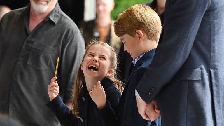 Princess Charlotte laughs as she conducts a band next to her brother, Prince George, during their visit to Cardiff Castle to meet performers and crew involved in the special Platinum Jubilee Celebration Concert taking place in the castle grounds later in the afternoon, as members of the Royal Family visit the nations of the UK to celebrate Queen Elizabeth II&#39;s Platinum Jubilee. Picture date: Saturday June 4, 2022.