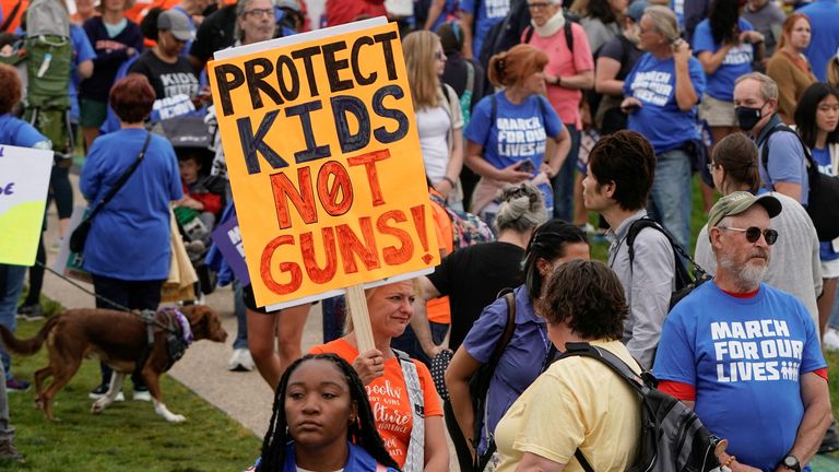People participate in the 'March for Our Lives' rally against gun violence Demonstrators hold placards as they take part in the 'March for Our Lives', one of a series of nationwide protests against gun violence, in Washington, D.C., U.S., June 11, 2022. REUTERS/Joshua Roberts