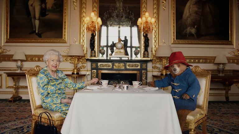     Queen Elizabeth II and Paddington Bear enjoy cream tea at Buckingham Palace, London, from a film which screened at the BBC Platinum Party at the Palace Heyday Films via AP)