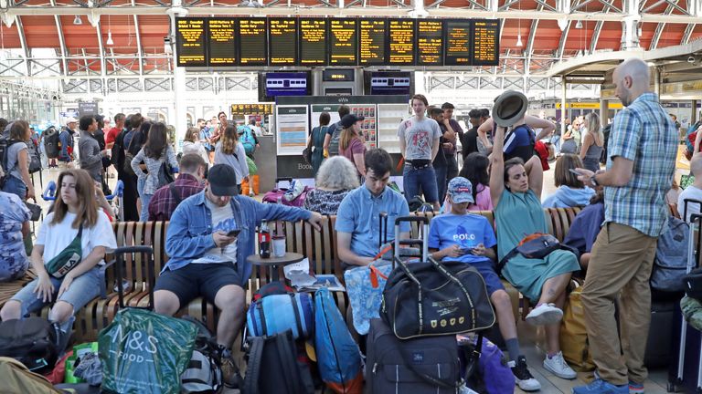 Passengers for the Glastonbury Festival wait at London's Paddington Station.
