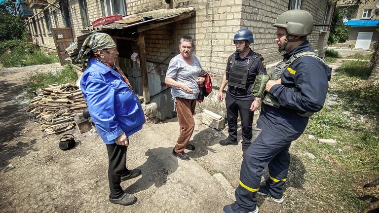 Rescuers talk to residents in a bid to help them reach safety