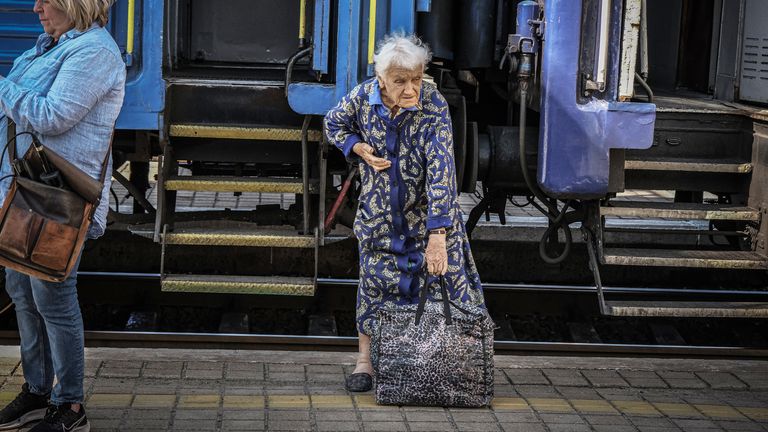 An elderly woman is one of those forced to flee by train from east Ukraine