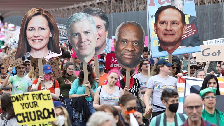 Abortion rights protesters in New York carry cutouts of Supreme Court justices Amy Coney Barrett, Neil Gorsuch, Brett Kavanaugh, Clarence Thomas and Samuel Alito 
