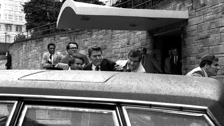 President Ronald Reagan being shoved into his limousine after being shot in 1981 Pic: AP  