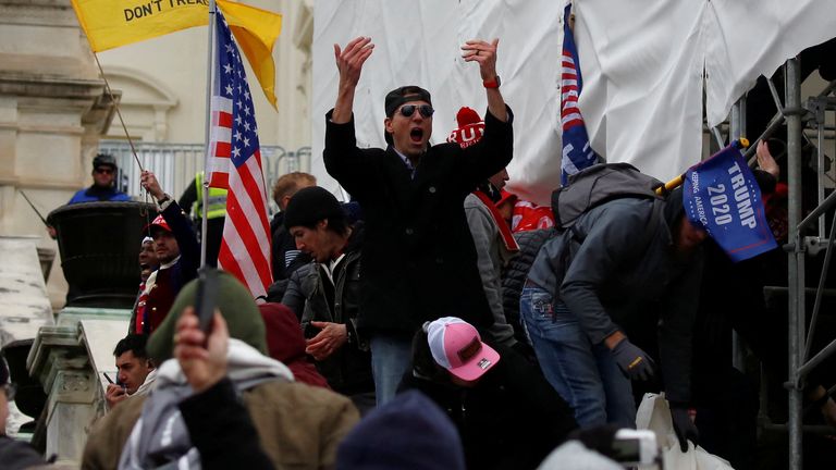 FILE PHOTO: A man, identified as Ryan Kelley in a sworn statement by an FBI agent, gestures as supporters of U.S. President Donald Trump make their way past barriers at the U.S. Capitol during a protest against the certification of the 2020 U.S. presidential election results by the U.S. Congress, in Washington, U.S., January 6, 2021. REUTERS/Jim Urquhart/File Photo
