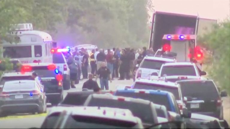 Police  officers work at the scene where dozens of people were found dead inside a trailer truck in San Antonio, Texas