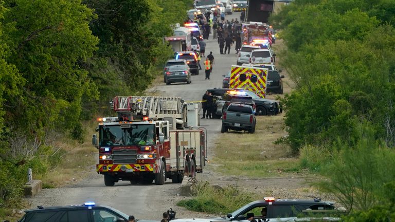 Police lock down the scene where a semi with multiple bodies was discovered, Monday, June 27, 2022, in San Antonio.  (AP Photo/Eric Gay)