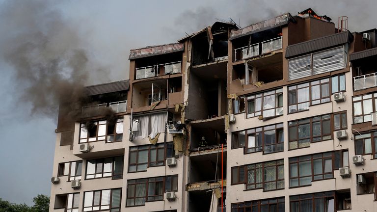 Smoke rises over a residential building damaged by a Russian missile strike in Kyiv