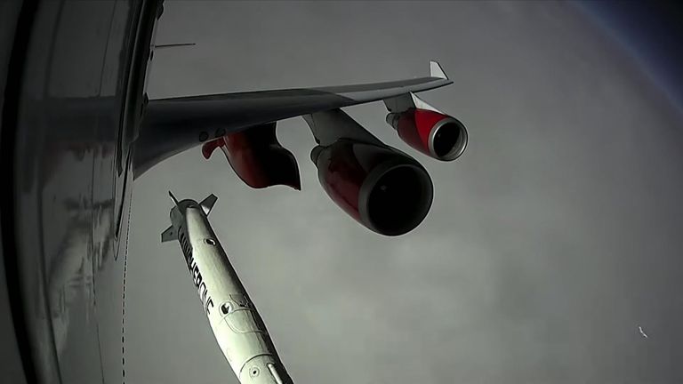 A rocket is carried under the wing of an aircraft before being released