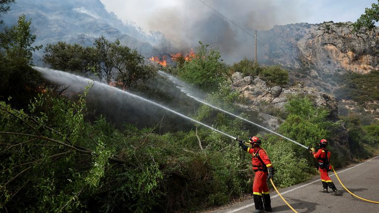 Members of the Military Emergencies Unit work to extinguish a wildfire near Artesa de Segre, Spain, June 16, 2022. REUTERS/Albert Gea
