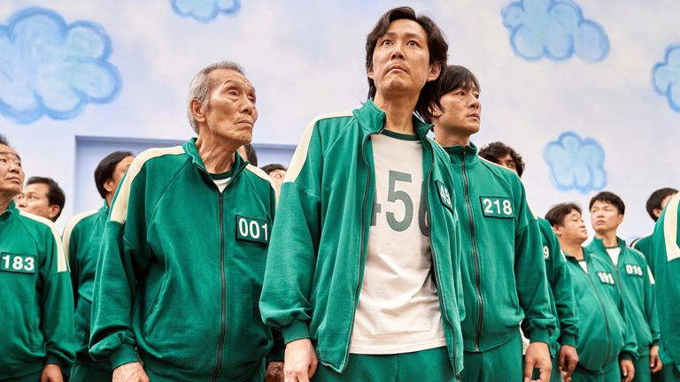 This image released by Netflix shows Lee Jung-jae, center, Park Hae-soo, right, and Oh Young-soo in a scene from the Korean series "Squid Game." (Netflix via AP)