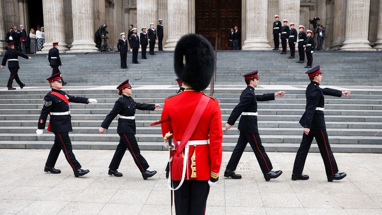 Members of the Armed Forces march on the steps of St Paul's