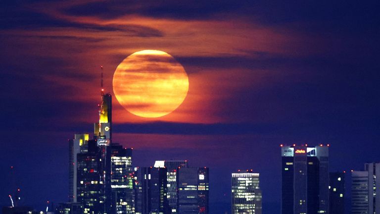 A full moon known as the "Strawberry Moon" rises behind the skyline of Frankfurt, Germany, June 14, 2022.  REUTERS/Kai Pfaffenbach
