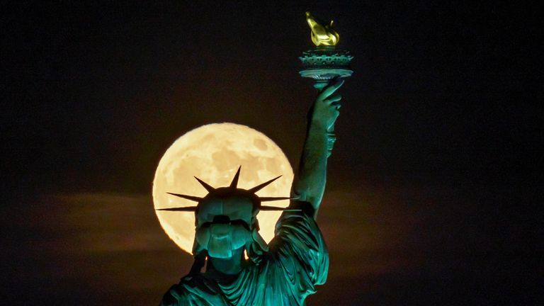 The Strawberry Supermoon rises in front of the Statue of Liberty in New York, late Tuesday, June 14, 2022. (AP Photo/J. David Ake)
PIC:AP