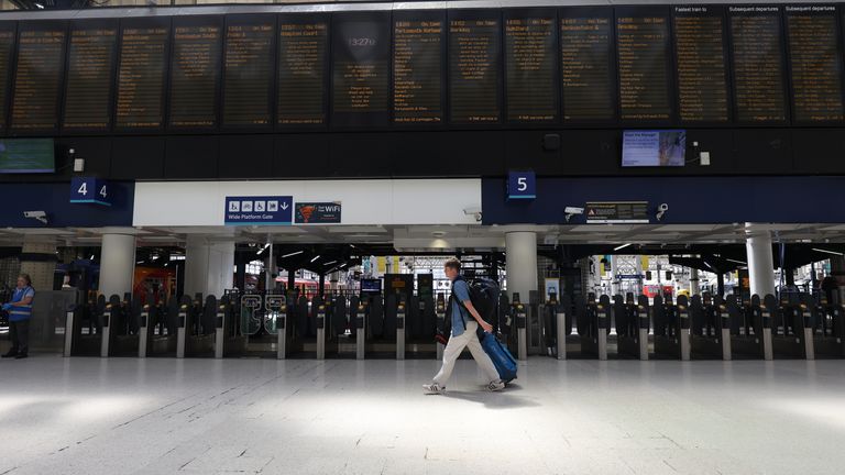 A passenger in Waterloo Station, central London, as train services continue to be disrupted following the nationwide strike by members of the Rail, Maritime and Transport union in a bitter dispute over pay, jobs and conditions. Picture date: Wednesday June 22, 2022.