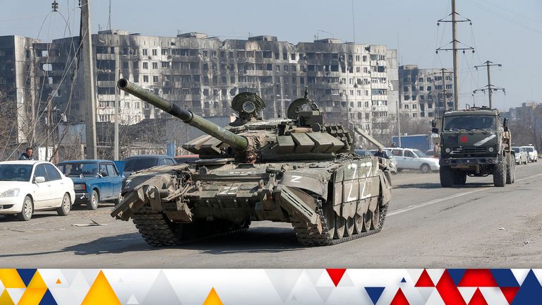 A tank and a military truck of pro-Russian troops drive along a road near burnt-out residential buildings in the course of Ukraine-Russia conflict in the southern port city of Mariupol, Ukraine April 5, 2022. REUTERS/Alexander Ermochenko