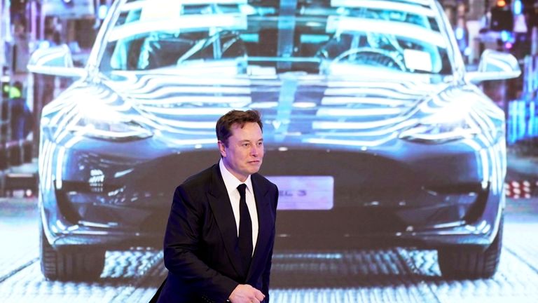 FILE PHOTO: Tesla Inc CEO Elon Musk walks next to a screen showing an image of Tesla Model 3 car during an opening ceremony for Tesla China-made Model Y program in Shanghai, China January 7, 2020. REUTERS/Aly Song/File Photo
