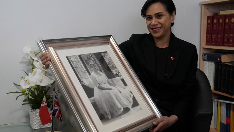 Tonga&#39;s High Commissioner to the UK, Titilupe Fanetupouvava&#39;u Tu&#39;ivakano, holds a portrait of her great grandmother Queen Salote Tupou III. Pic: AP