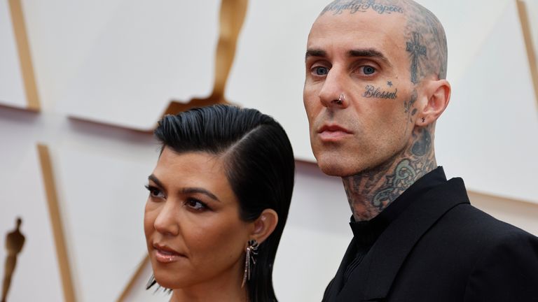 Kourtney Kardashian and Travis Barker pose on the red carpet during the Oscars arrivals at the 94th Academy Awards in Hollywood, Los Angeles, California, U.S., March 27, 2022. REUTERS/Eric Gaillard
