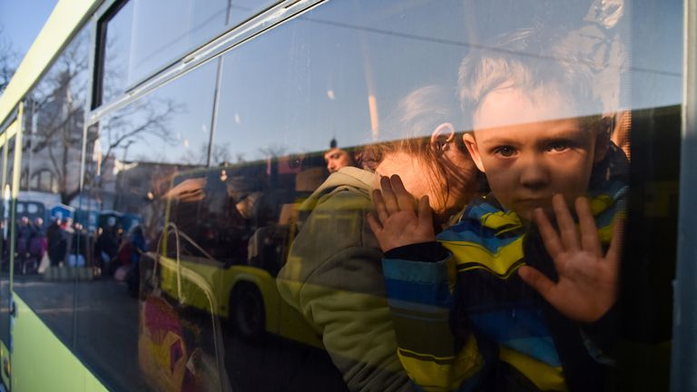 A child looks out from a window of a bus for refugees fleeing Russia&#39;s invasion of Ukraine, in Lviv, Ukraine, March 13, 2022. REUTERS/Pavlo Palamarchuk
